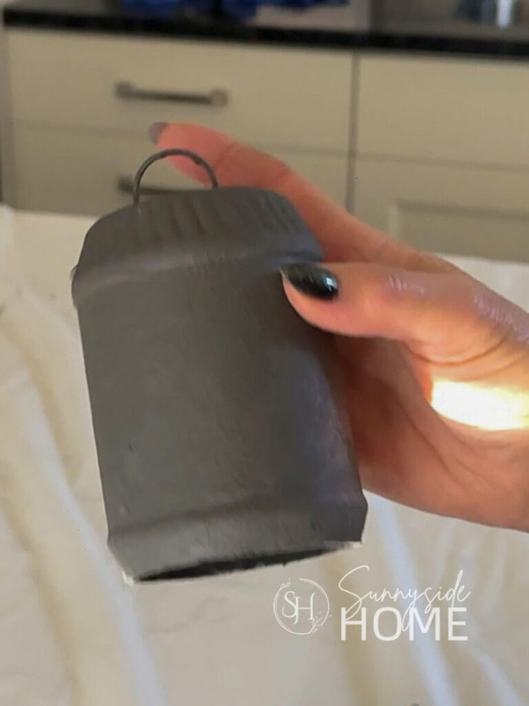 Grey undercoat paint applied to recycled peanut butter container.