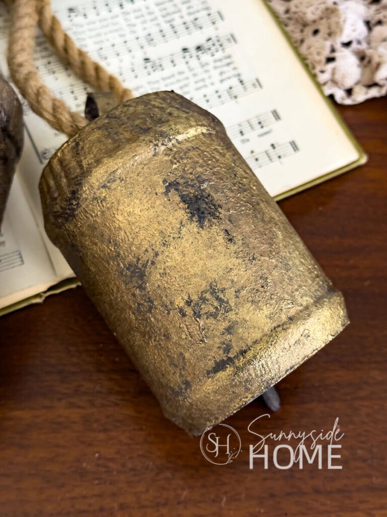 Styled DIY Christmas bell on a Christmas hymn book.