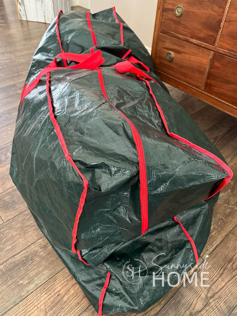 Large green zippered bag is used to store and organize Christmas tree