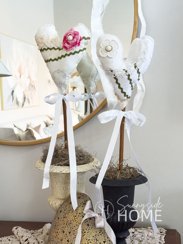 DIY Valentine heart decor styled on an entry table with brass heart and ribbon.