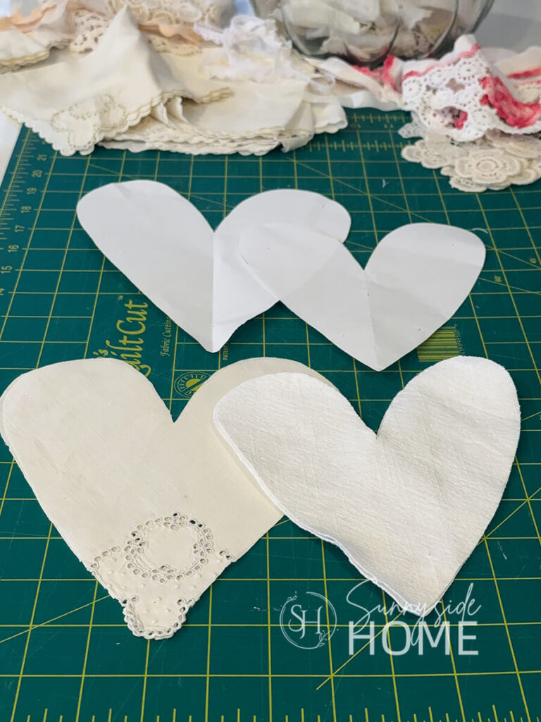 Hearts are cut from old vintage napkins and tablecloth to make Valentine heart decor.