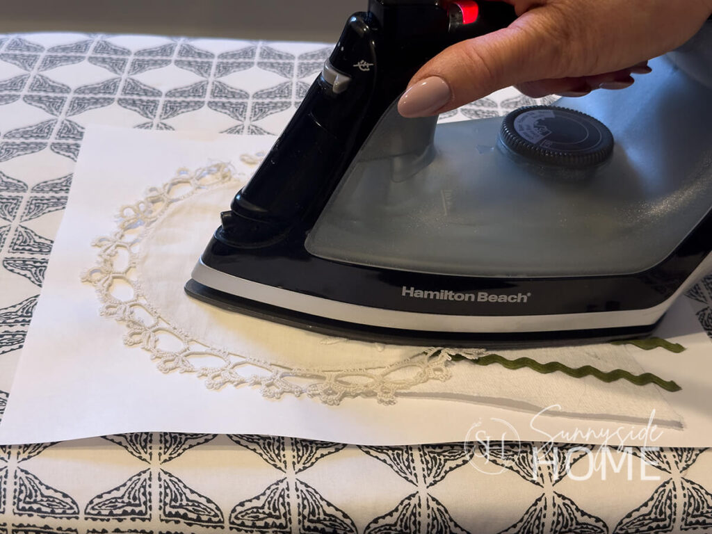 Vintage doily is adhered to linen heart with hot iron and fusible web.