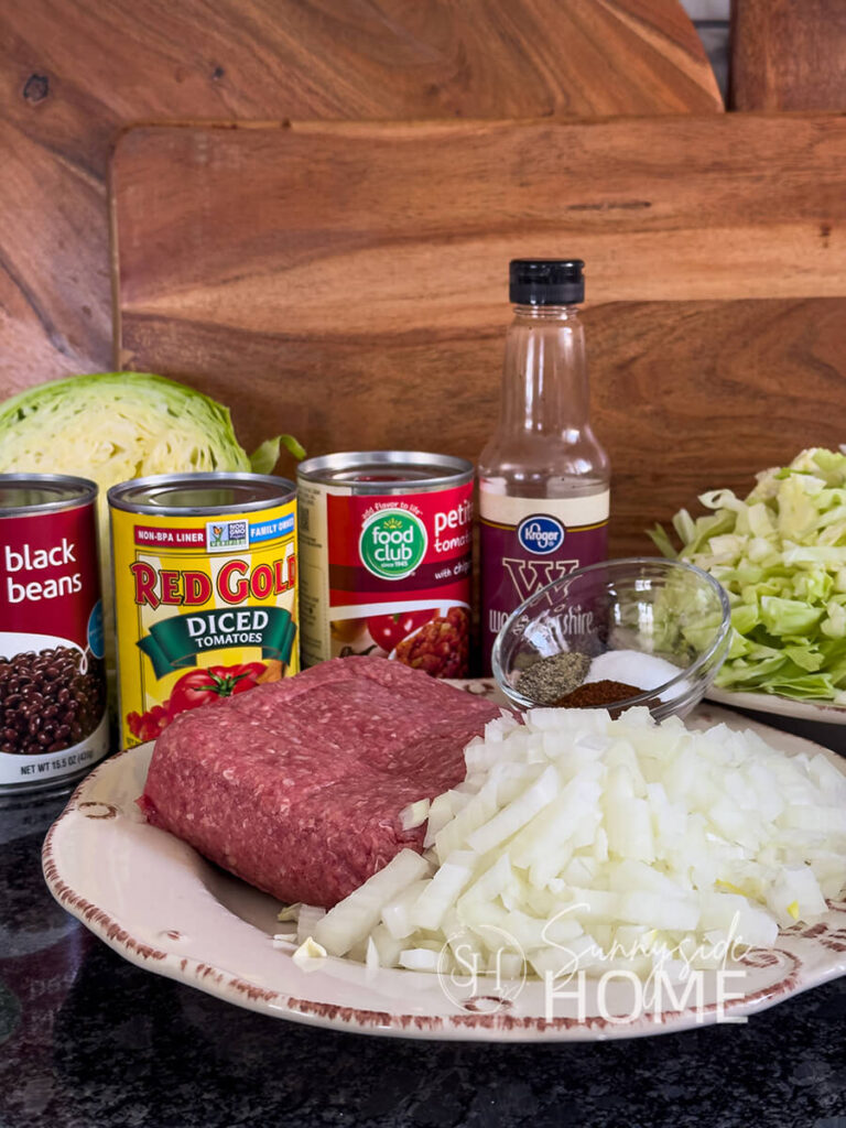 Ingredients for an easy beef and cabbage soup with a kick. Ground beef, diced yellow onion, shredded cabbage, black beans, diced tomatoes, tomatoes with chipotle peppers, Worcestershire sauce and seasonings.