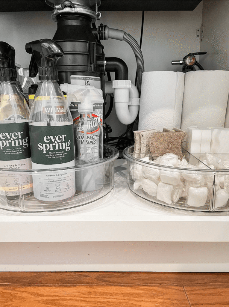 Two turn table are used to store clean products under the kitchen sink and around the garbage disposal.
