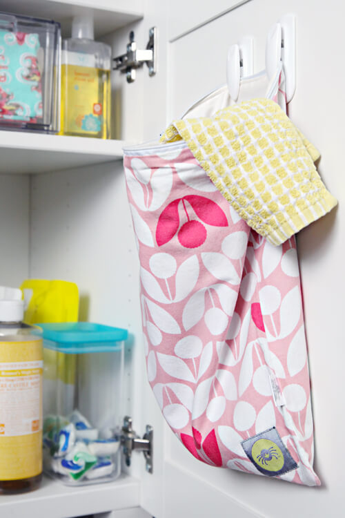A wet bag is mounted to the cabinet door for storing dirty rags.