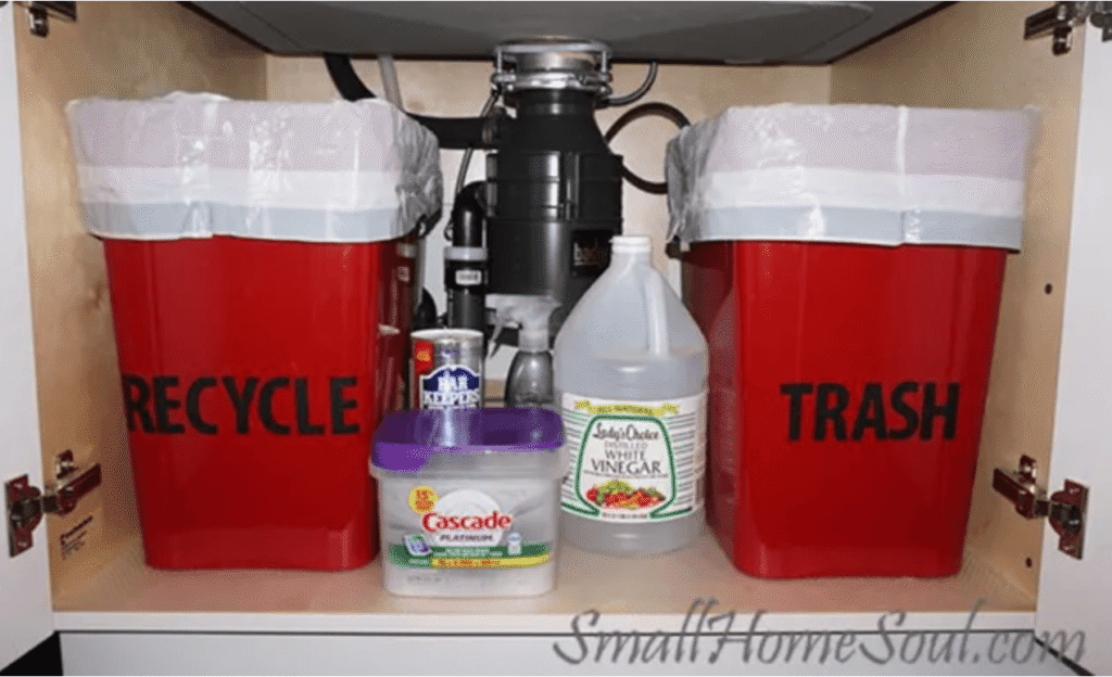 Recycling and trash zones are created under the kitchen sink around the pipes and disposal.