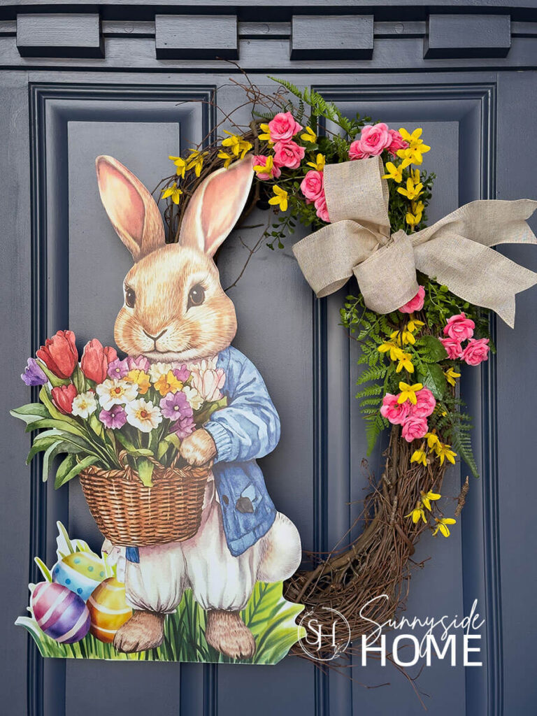 DIY Easter wreath hung on a navy blue front door.