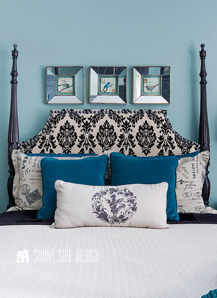 A neatly made upholstered 4 poster bed, daily make bed for a neat a tidy home.