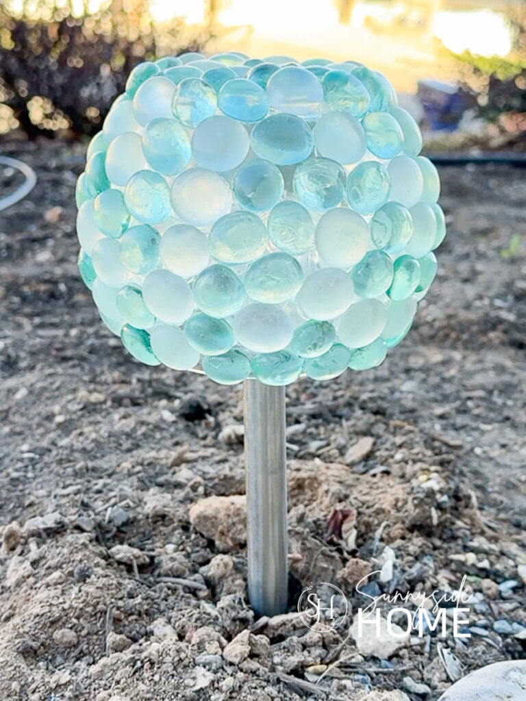 Dollar store solar lights gets a glow-up with a glass gem orb shade.