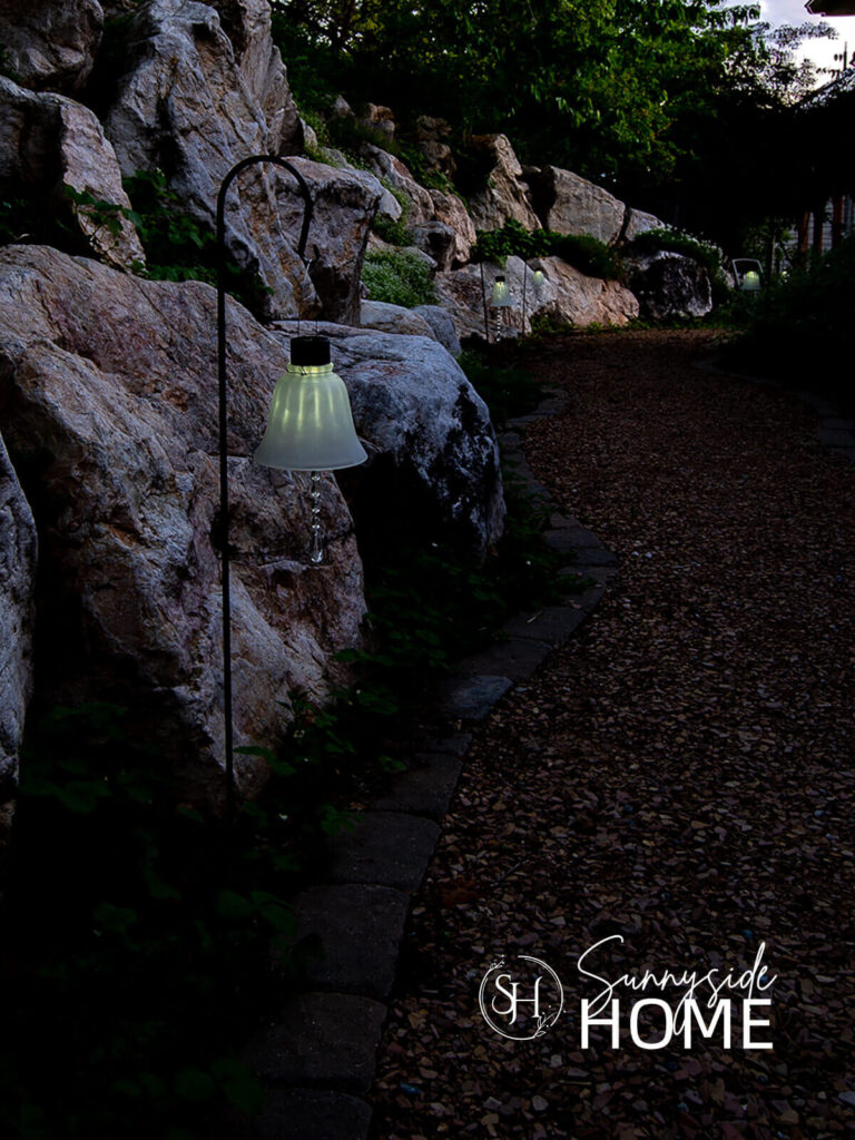 Solar light along a garden path at dusk.