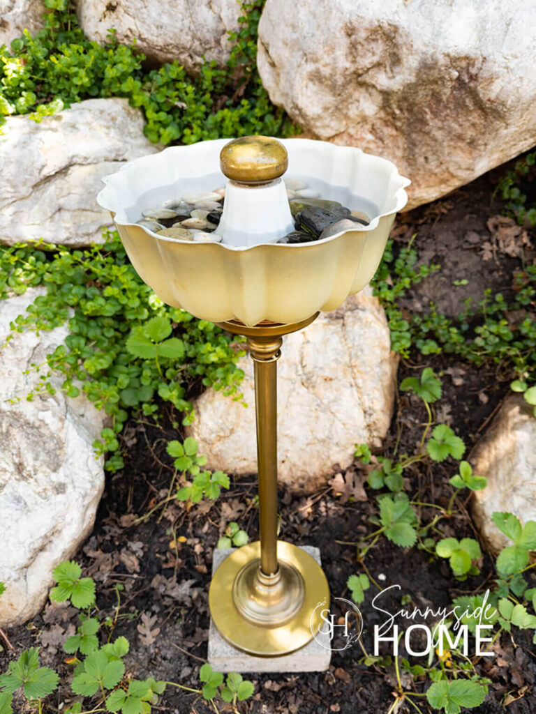 Fun garden decor with a whimsical bird bath made from a bundt pan, door knob and a table base.