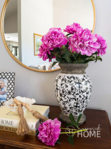 Styled pink peonies in a vase, with tips for how to make peonies last longer in a vase.