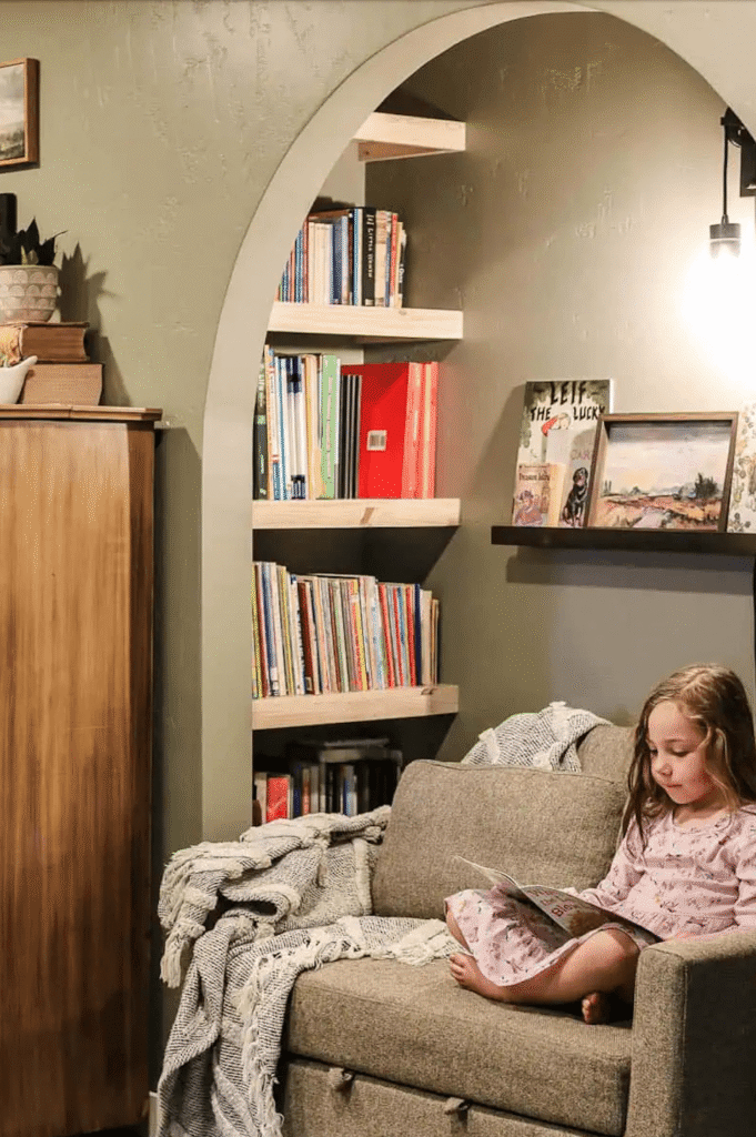 An unused closet is covered to a cozy reading space with a small sofa and shelves.