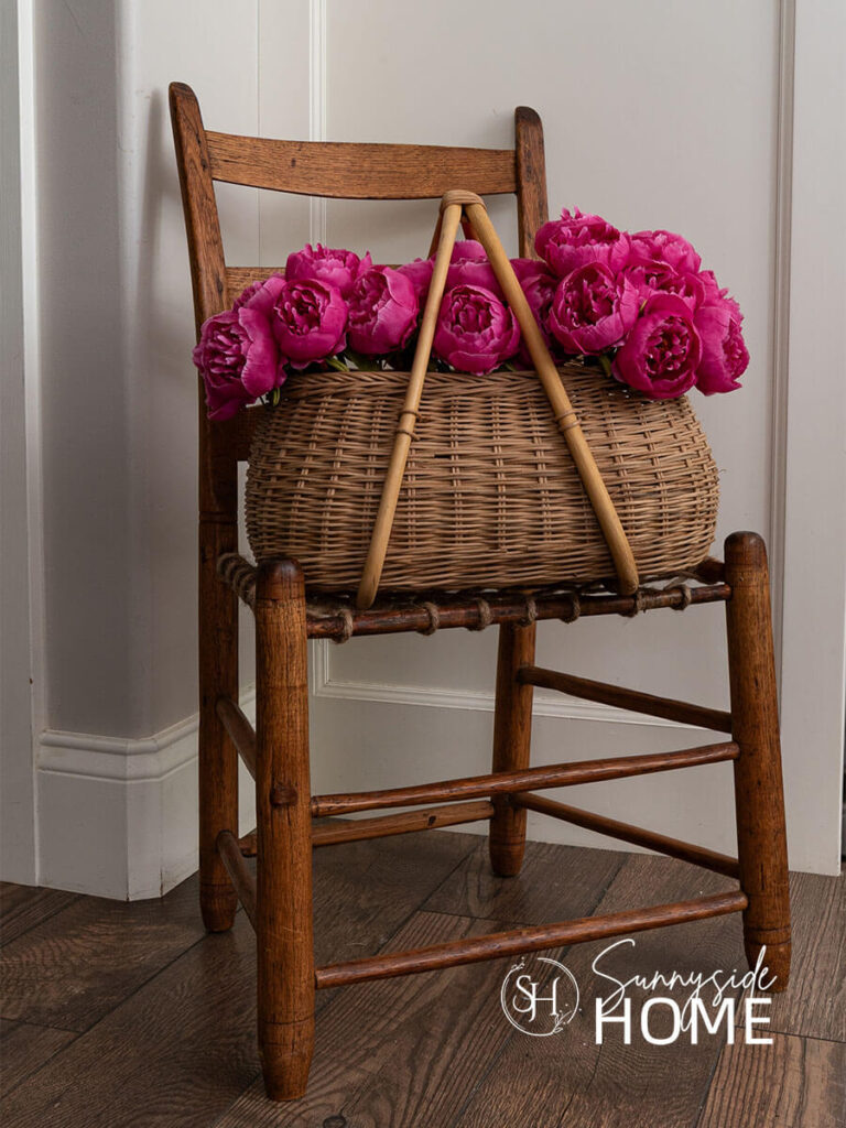 Thrift store share with a basket of pink peonies in the kitchen.