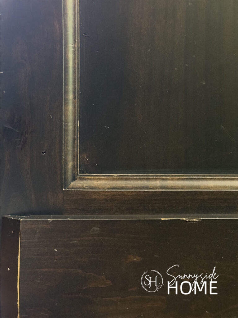 Kitchen cabinet base with chipped finish.