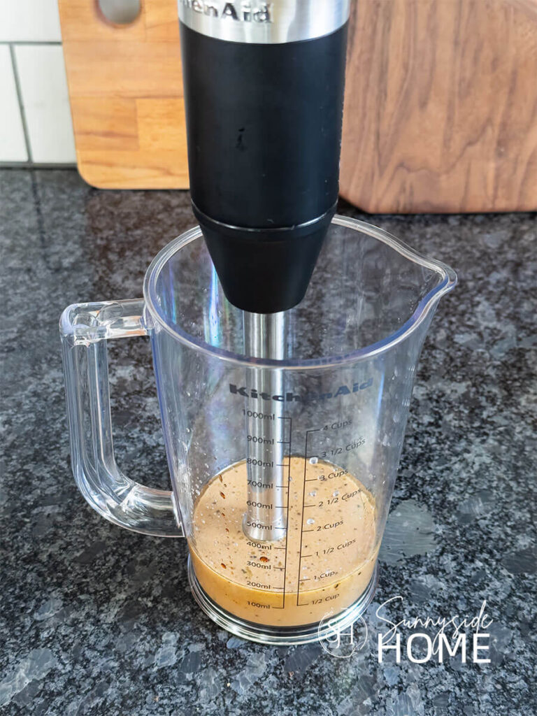 The ingredients of lime juice, balsamic vinegar, organic pure maple syrup, organic extra virgin olive oil, salt and pepper are emulsified in a container with an immersion blender.