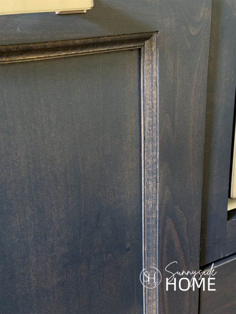 Kitchen cabinet door after fixing the chips with a stain pen.