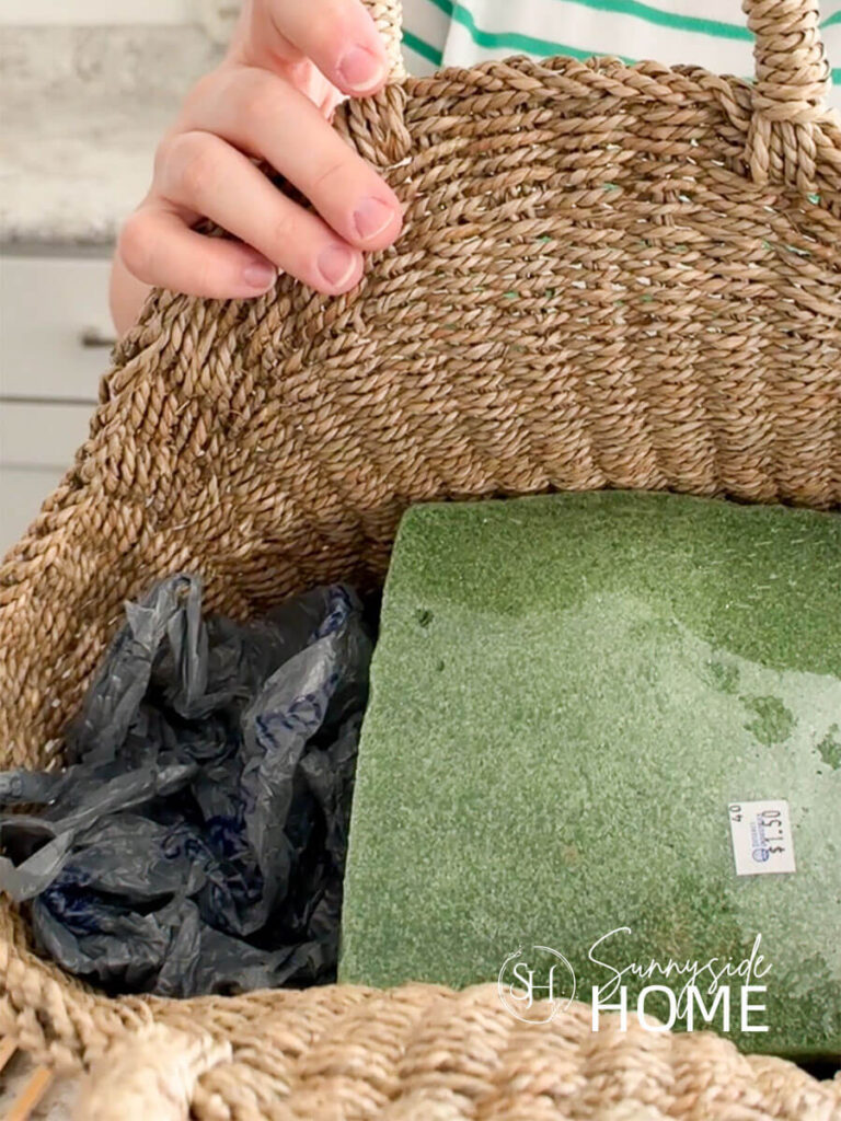 View inside a thrifted basket with a thirfted piece of styrofoam and grocery bags placed on the sides of the styrofoam to keep it in position.