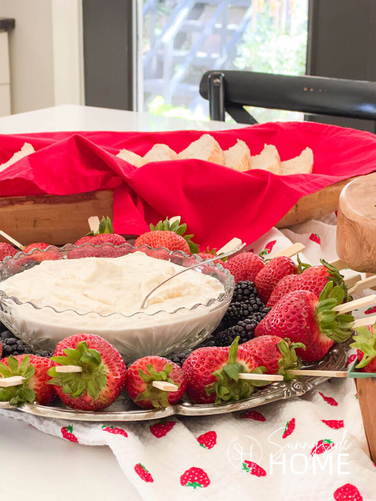 Bridal Shower buffet with berry kabobs, vanilla fruit dip and a basket of sour dough bread styled with a strawberry table runner.