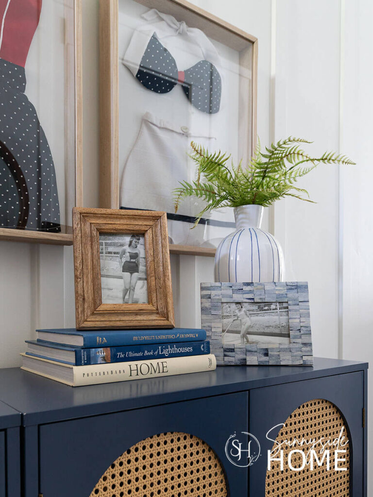 Decorate with blue and white with coffee table books on a blue entry cabinet. Another way to decorate with blue and white is a blue and white photo frame.