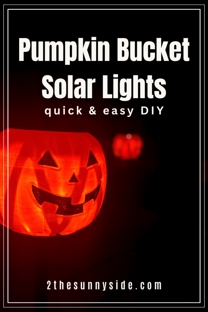 Pinterest image, jack-o-lantern Pumpkin Bucket Solar light glowing along a pathway at night.