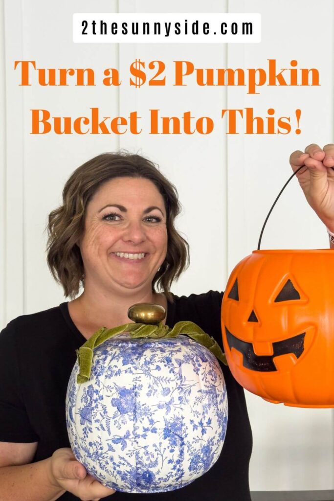 Pinterest image: A woman holding a orange pumpkin bucket and a blue and white chinoiserie pumpkin embellished with green velvet ribbon. Turn a $2 Pumpkin Bucket Into This!