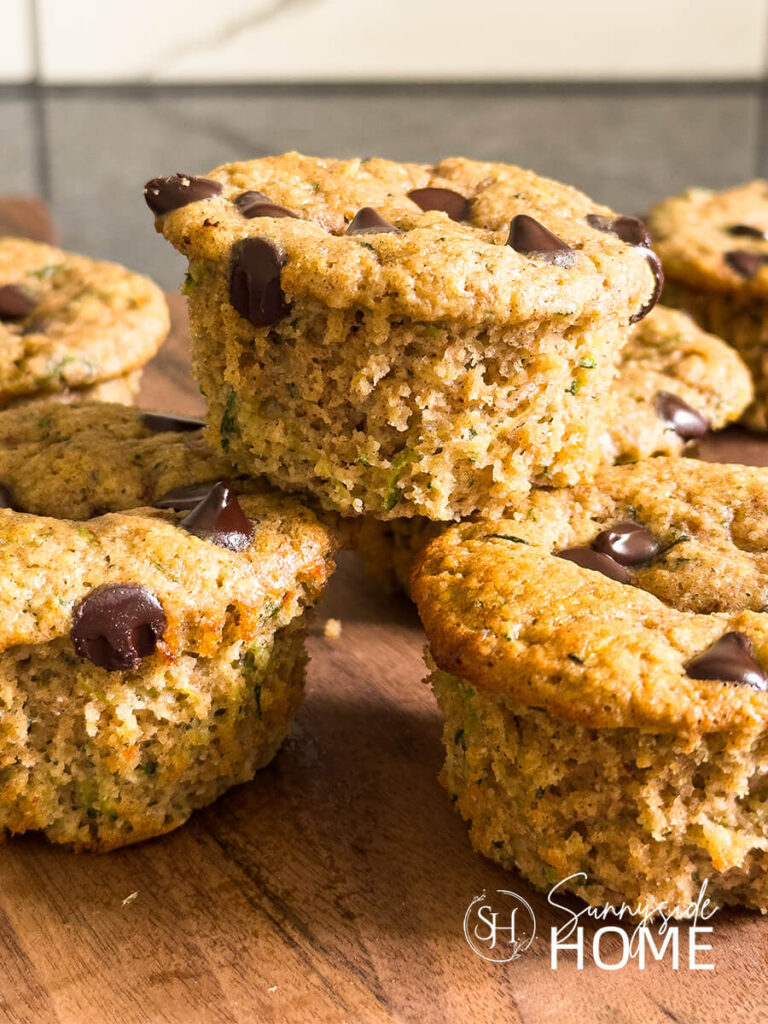A plate of moist protein zucchini muffins with chocolate chips.