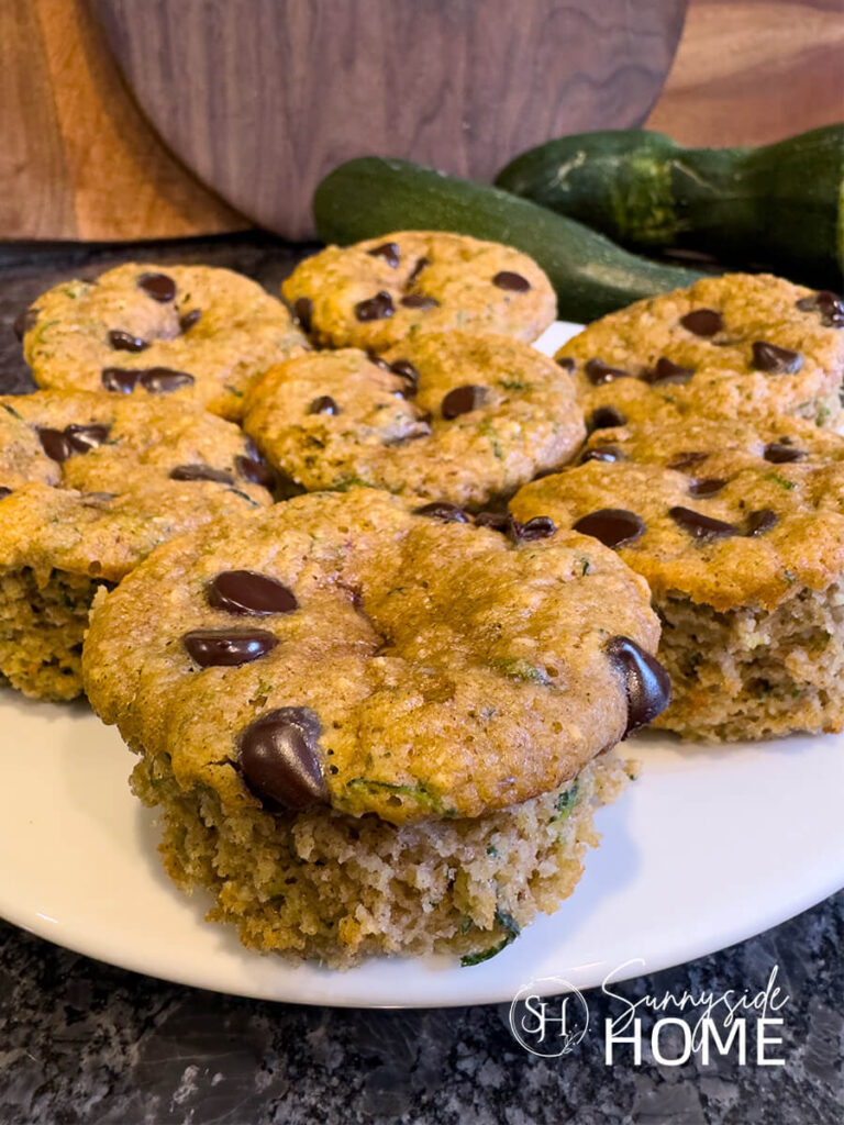 A plate of moist protein zucchini muffins with chocolate chips.