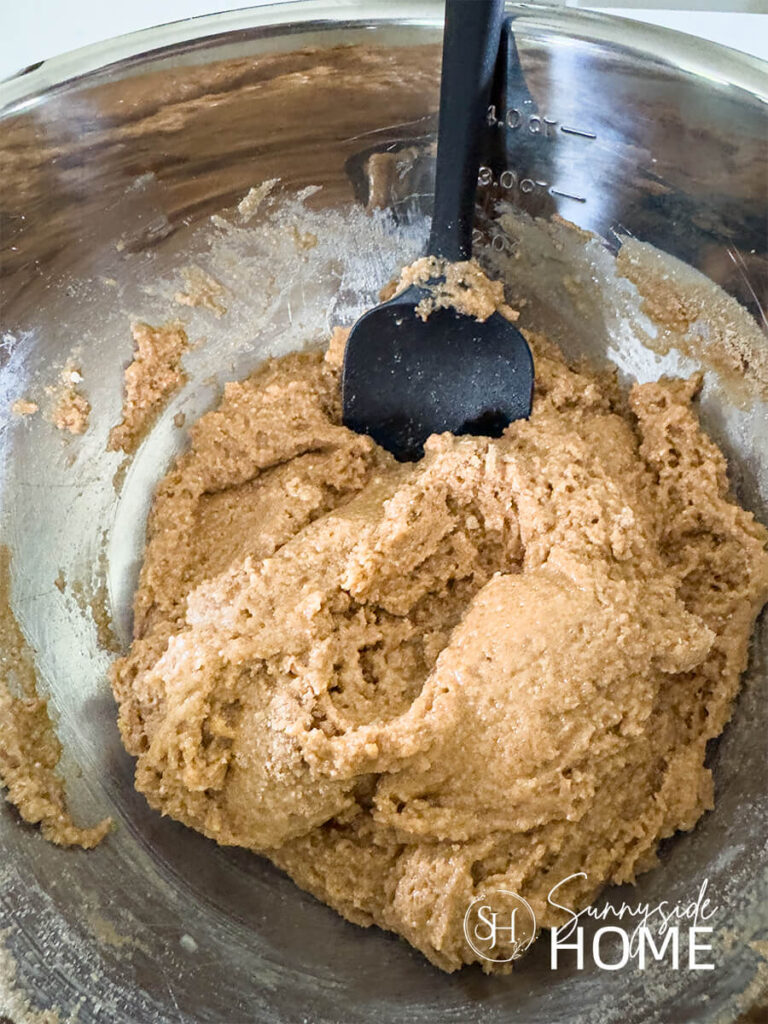 Zucchini batter after the wet and dry ingredients are combined in a stainless steel bowl.