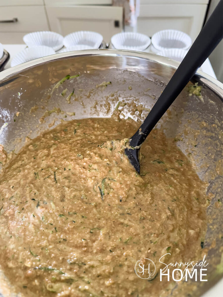Protein Zucchini Muffins batter in a stainless steel bowl.