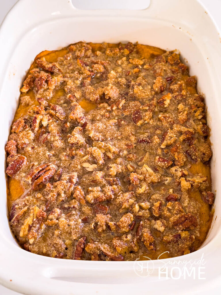 Baked sweet potato casserole in a white baking dish.