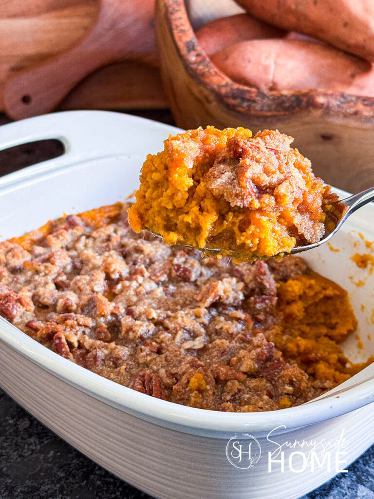 A spoonful of decadent sweet potato casserole from the dish.
