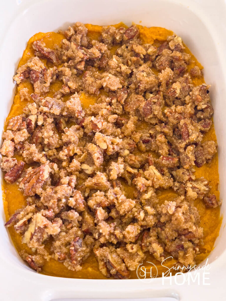 Buttery pecan topping mixture sprinkled over the sweet potato casserole.